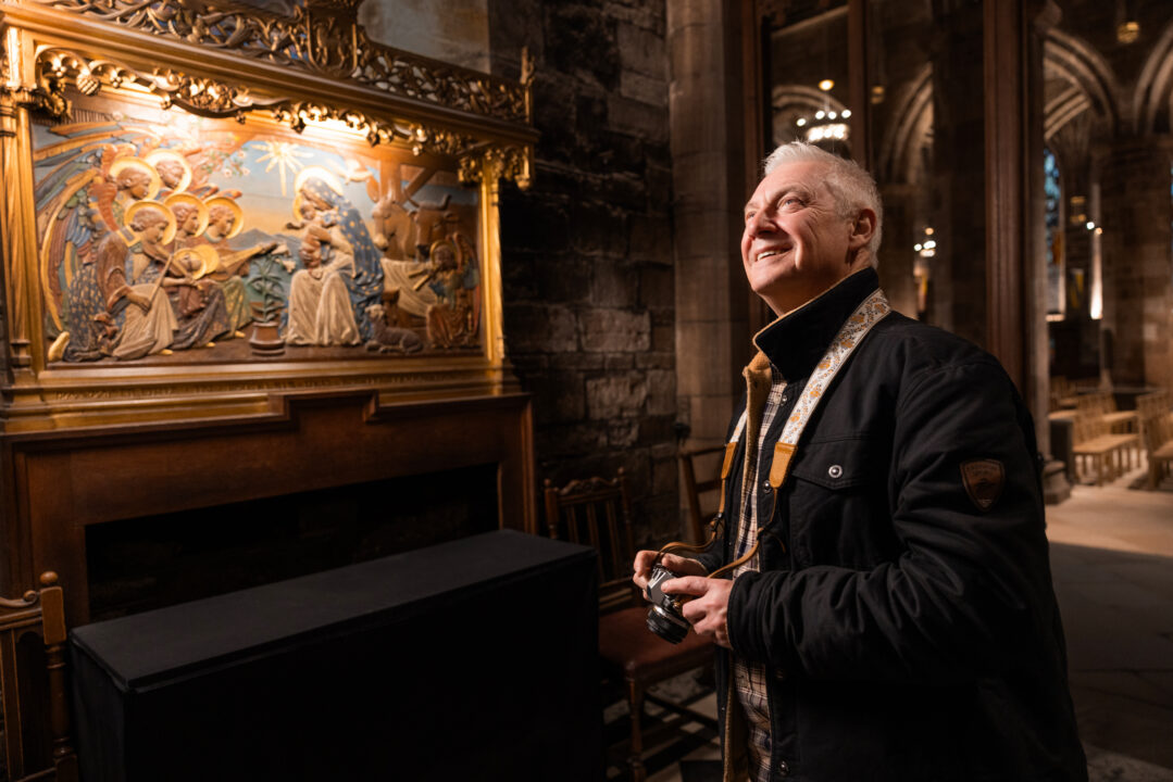 Man looking at painting inside St Giles Cathedral