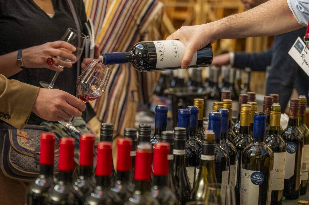 Close-up of a table filled with bottles of wine.