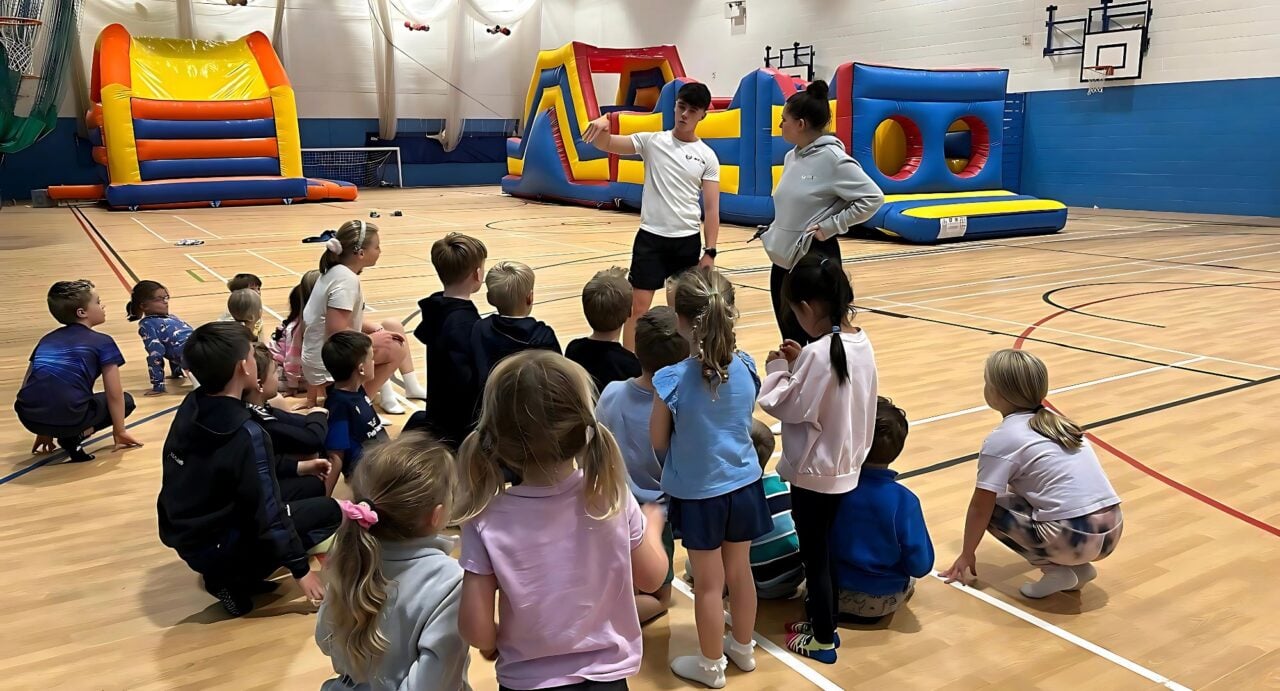 Group of young children in an indoor gym.
