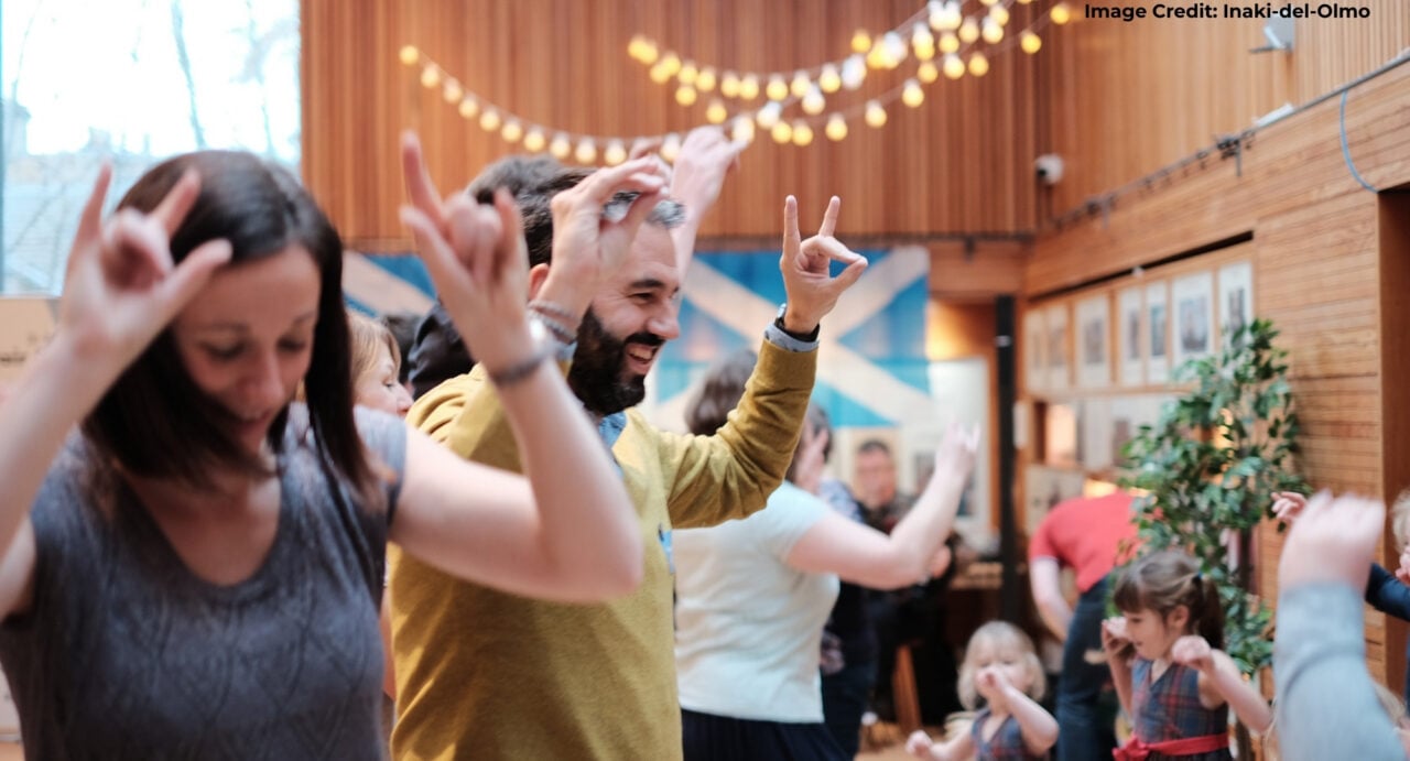 A group of adults and children dancing.