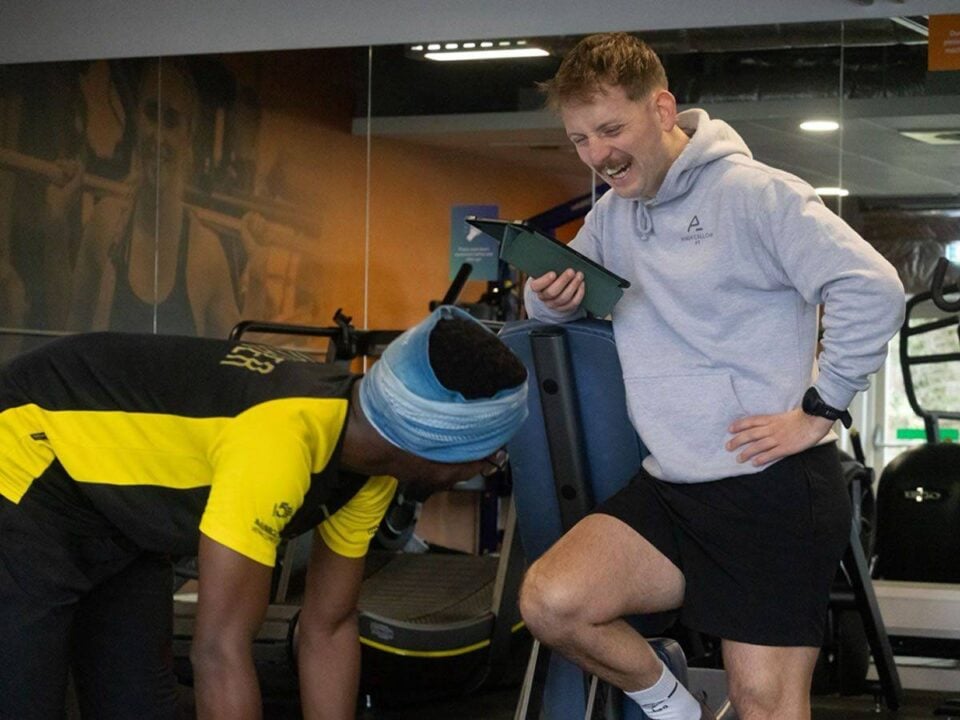 Personal trainer running workout in gym