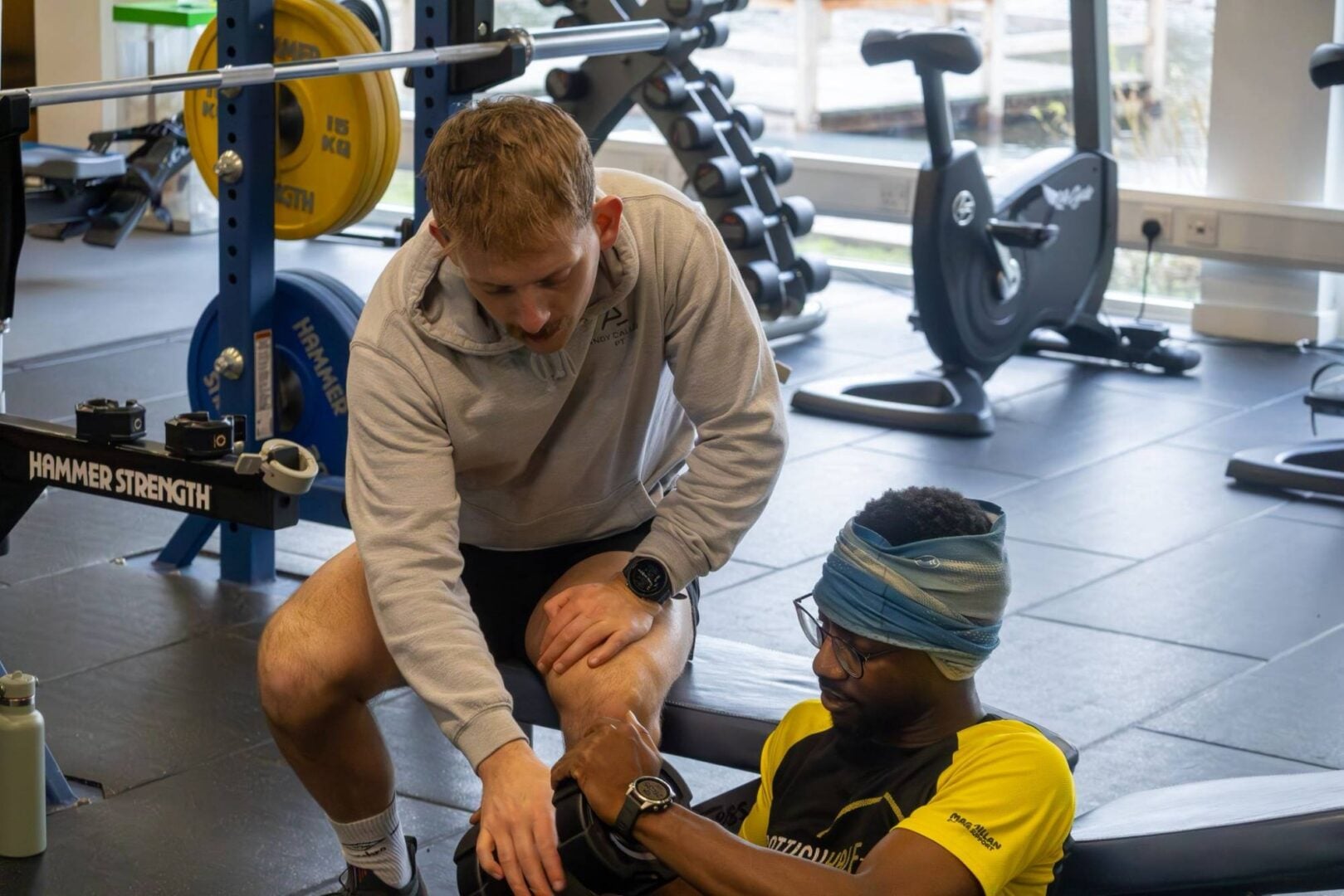 Personal trainer in gym running training session with client.