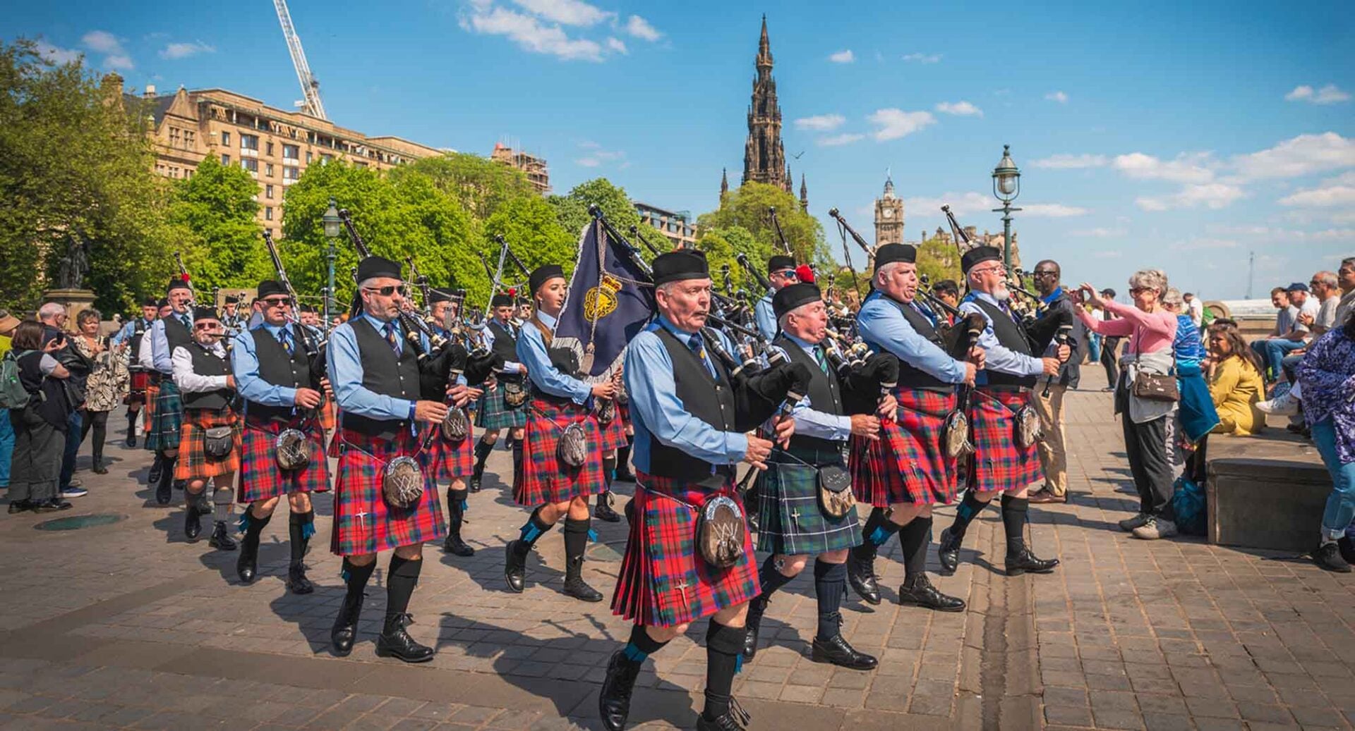 A group of pipers wearing traditional Scottish dress.