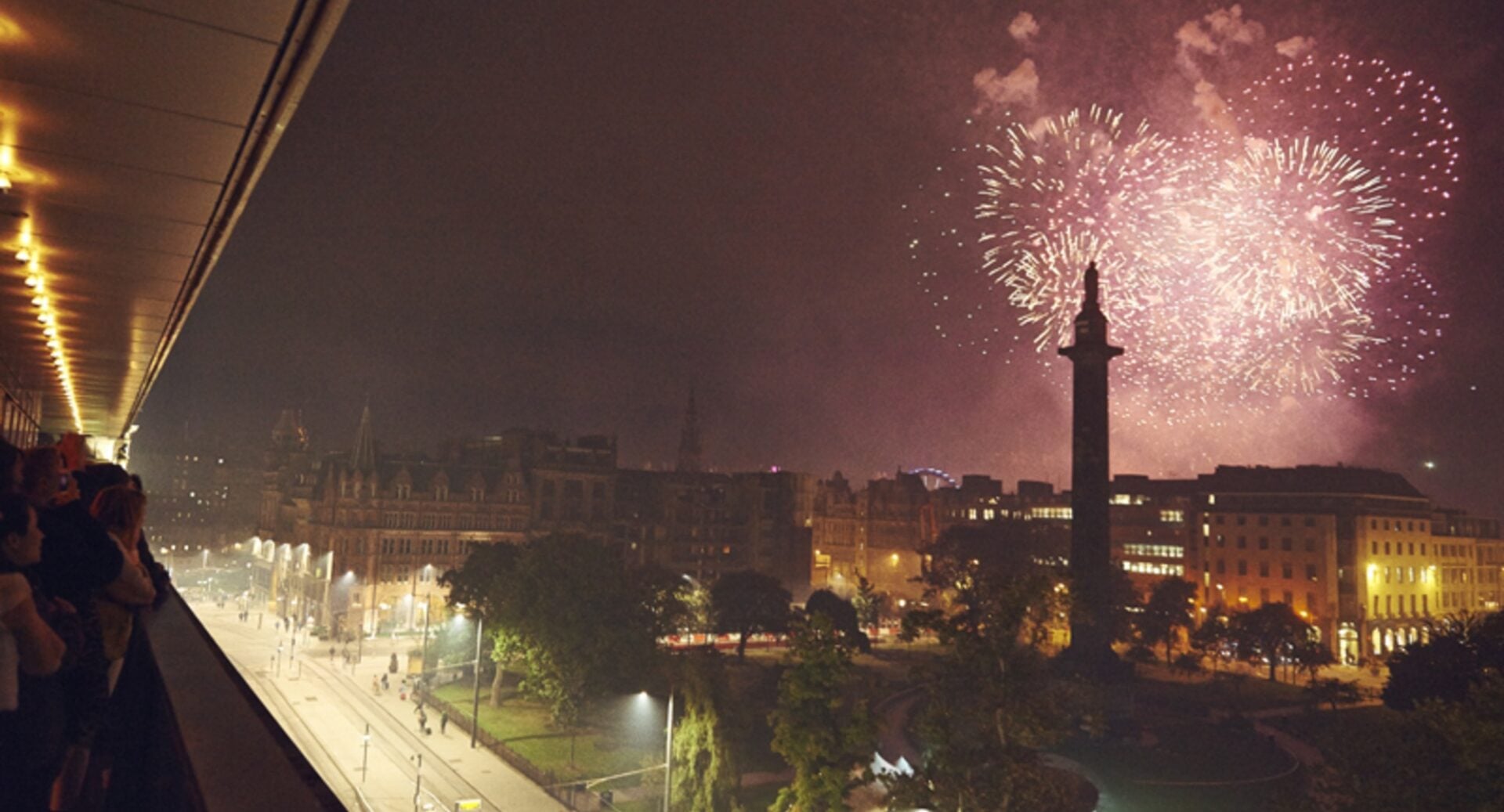 City skyline view at night-time, with fireworks