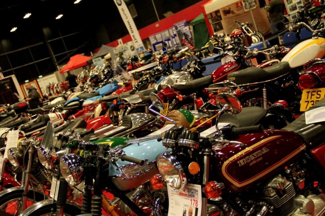 A large room filled with rows of motorbikes.