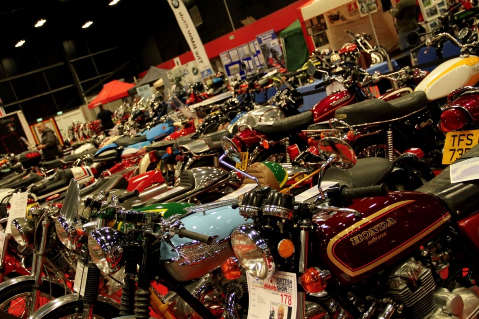 A large room filled with rows of motorbikes.