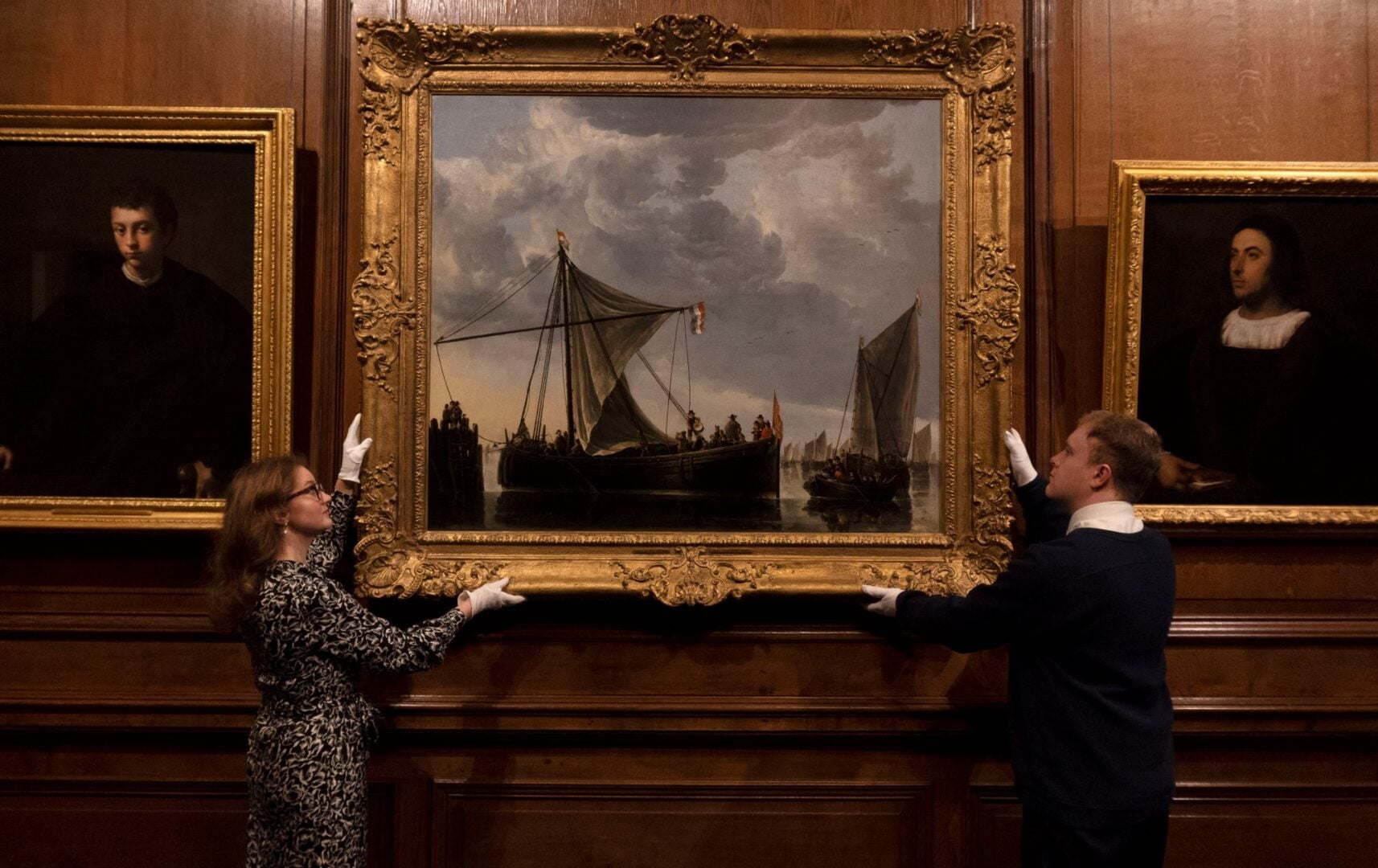 Members of staff at the Palace of Holyroodhouse put the final touches to the new display Italian, Dutch & Flemish Paintings: Highlights from Buckingham Palace.