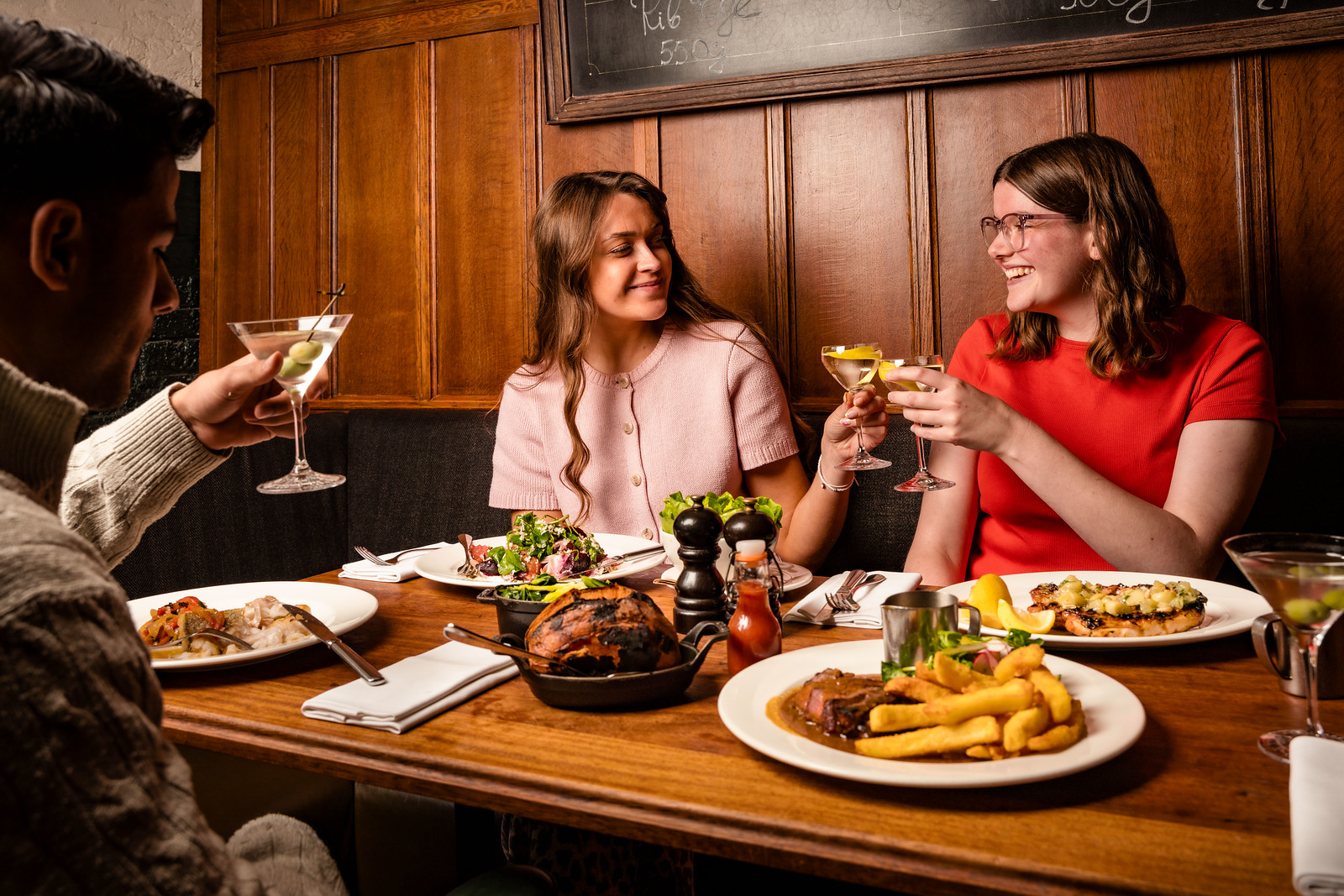 Group of people enjoying steak and side at Hawksmoor