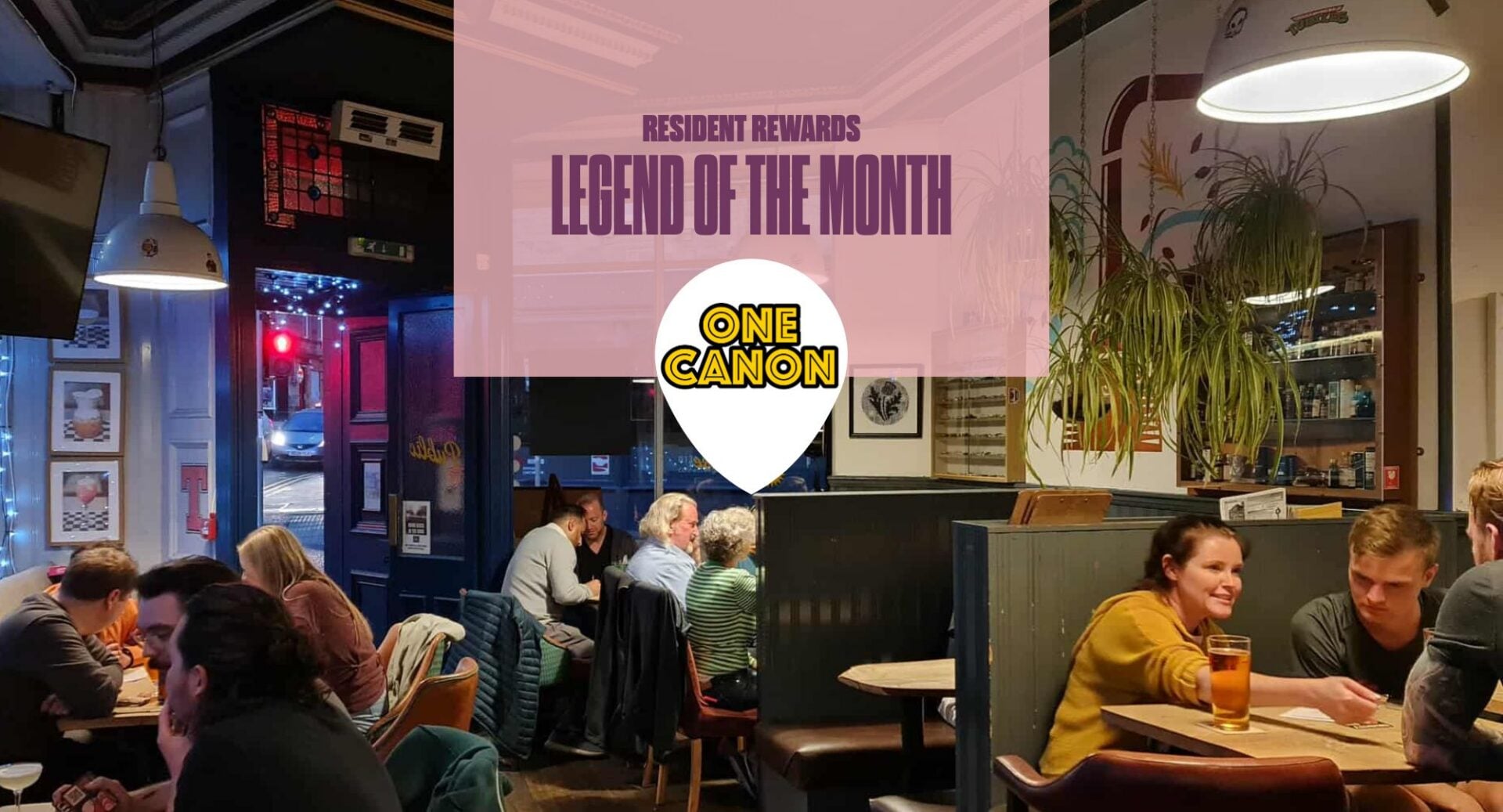 One Canon pub with people in seats and Pink box with Legend of Month and One Canon logo
