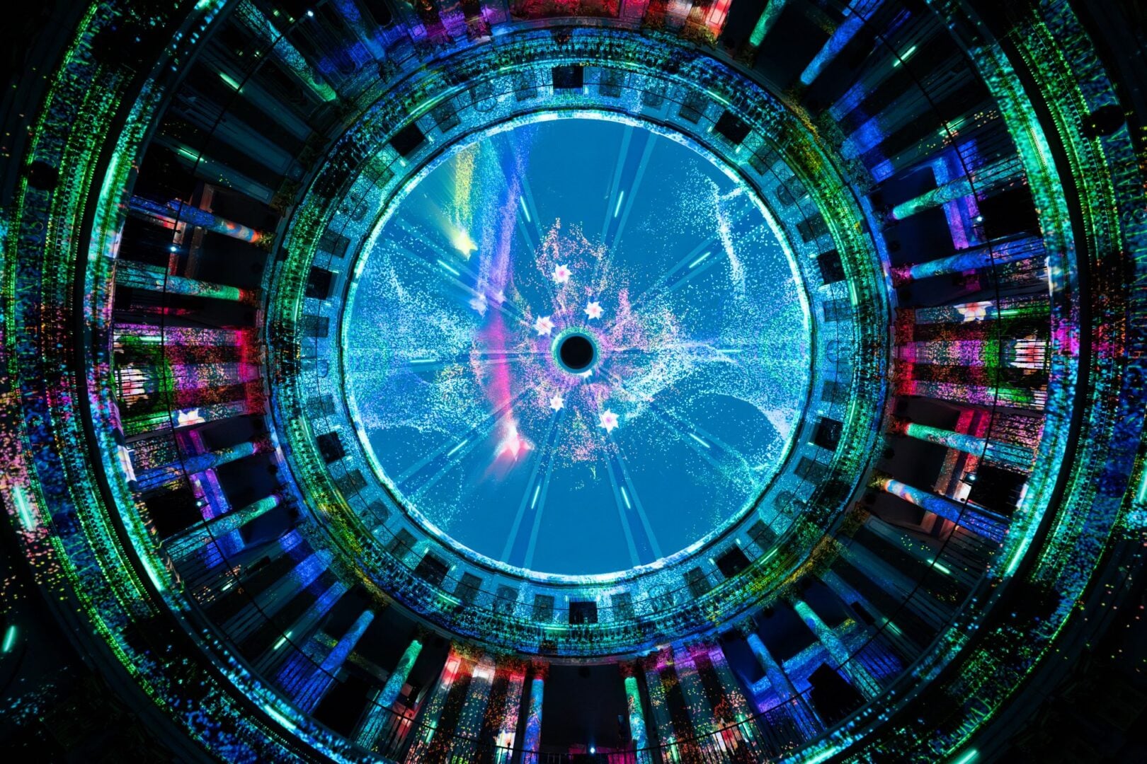 Close-up of a vaulted ceiling illuminated by different coloured lights.