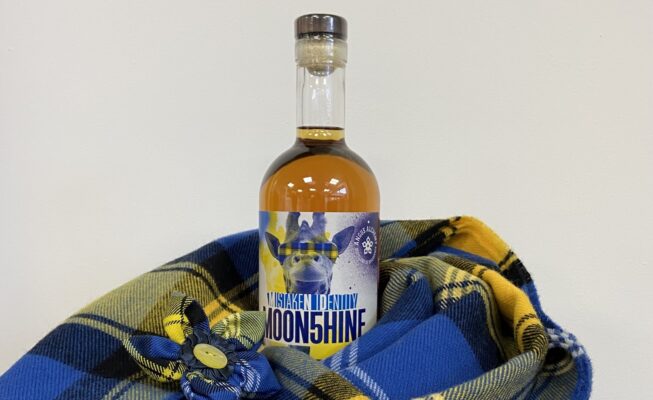 Doddie-moonshine bottle and scarf at ScotlandShop pop up