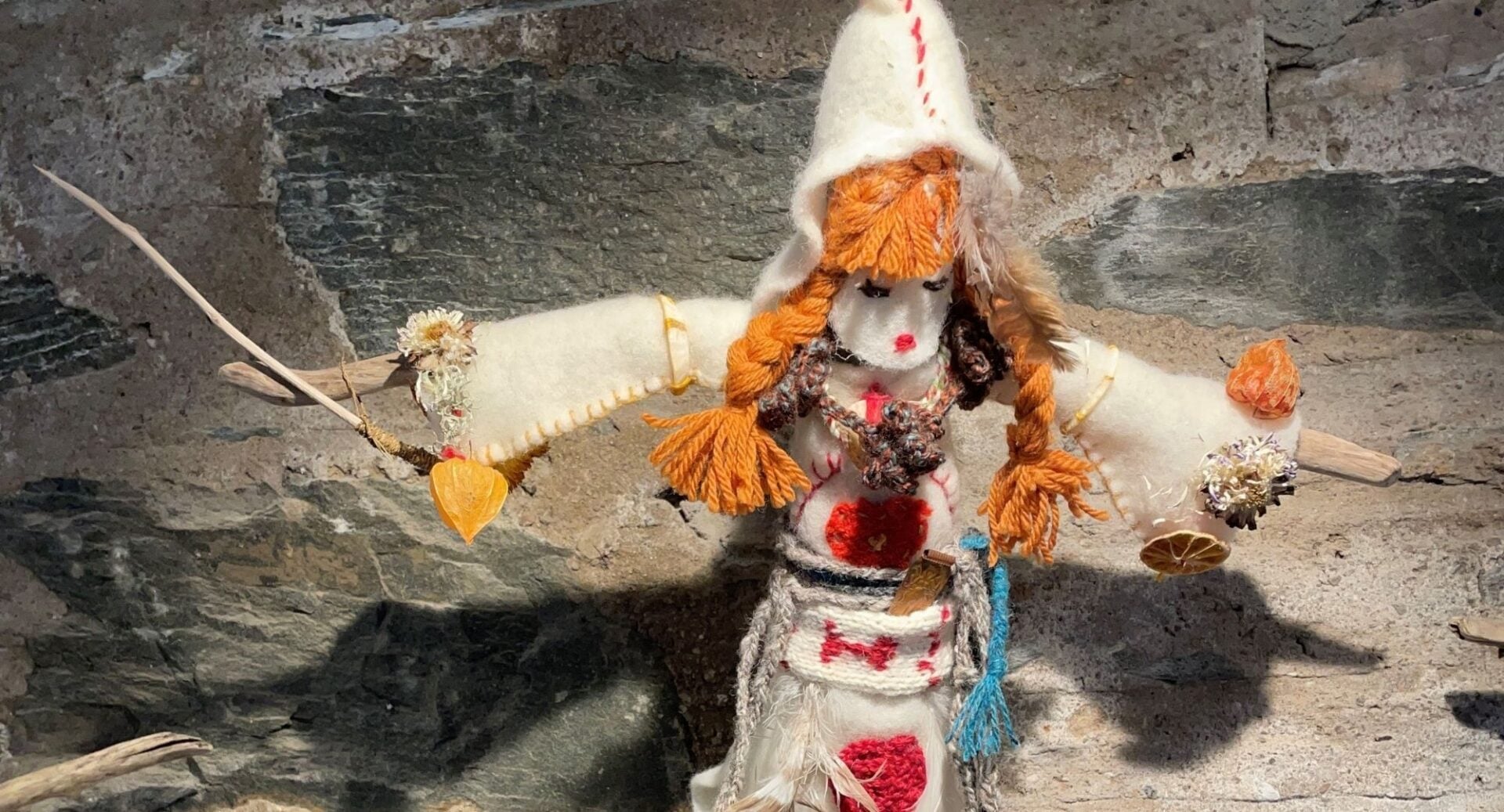 Small handmade doll, made with wool, twigs and felt.