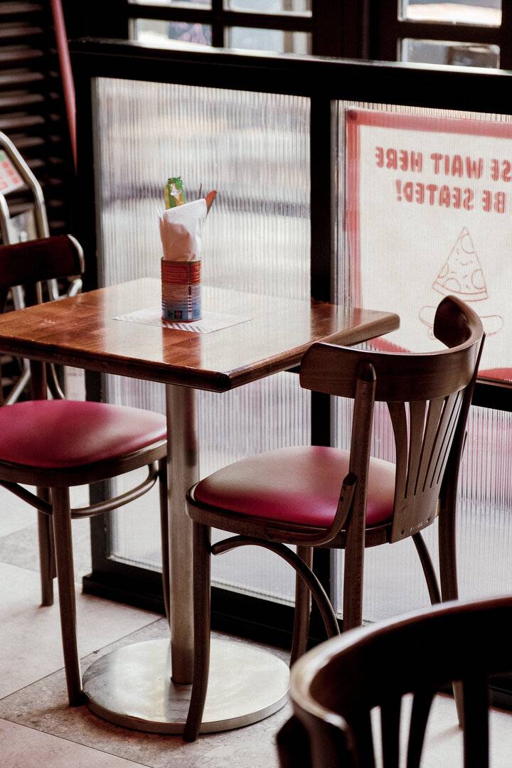 two chairs at a table next to a window,© Civerinos