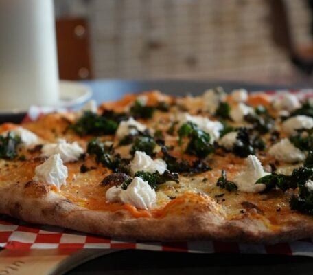 Kale and truffle whipped ricotta New Haven pizza on counter top,© Civerinos