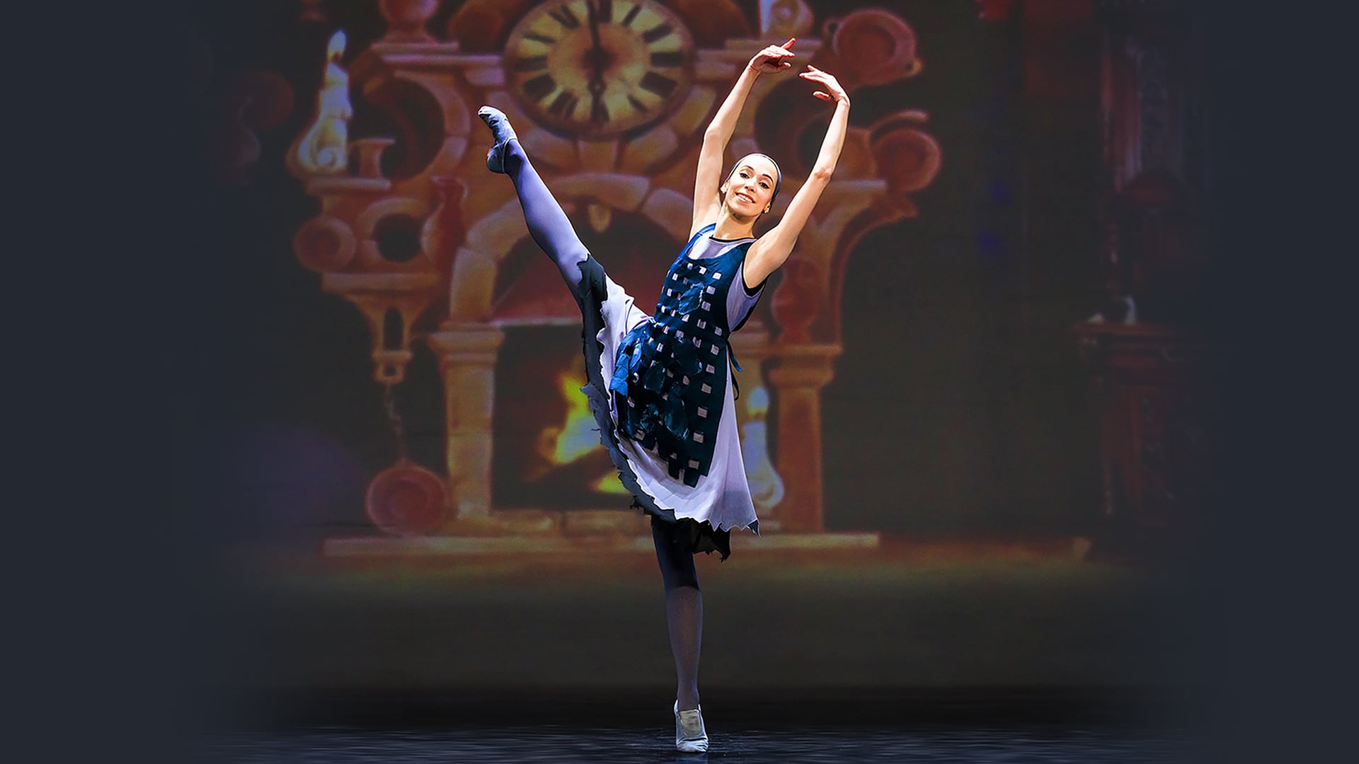 A woman dancing on stage, in a ballet pose.