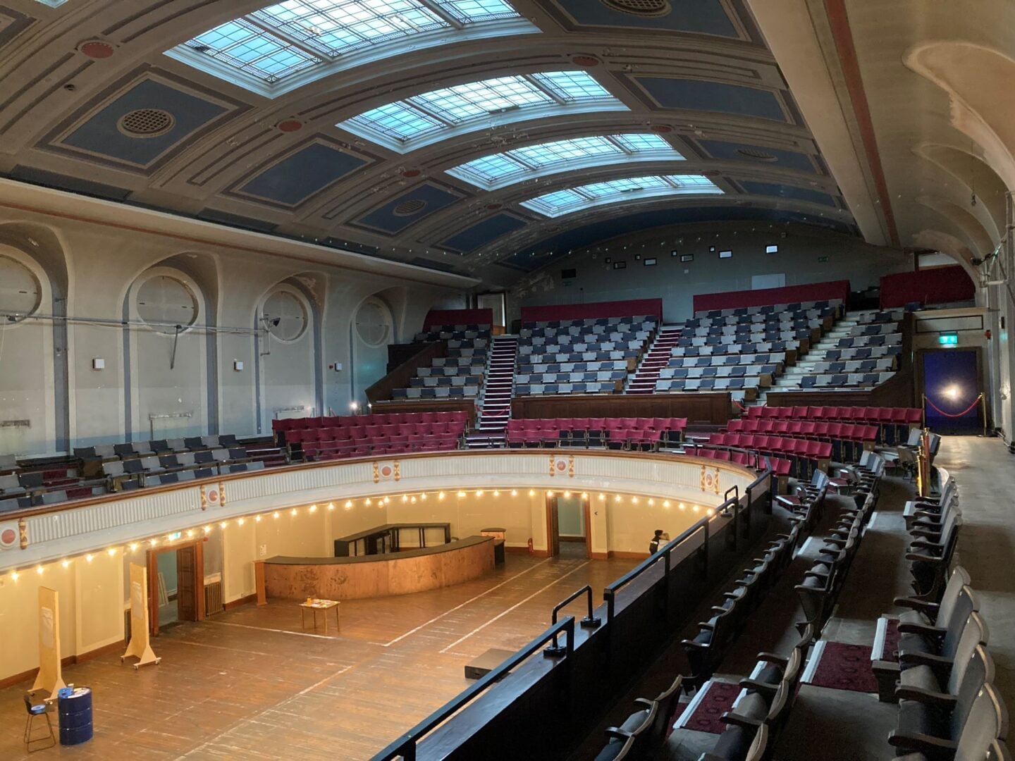 Ground floor and upper levels of a theatre, with glass ceiling.