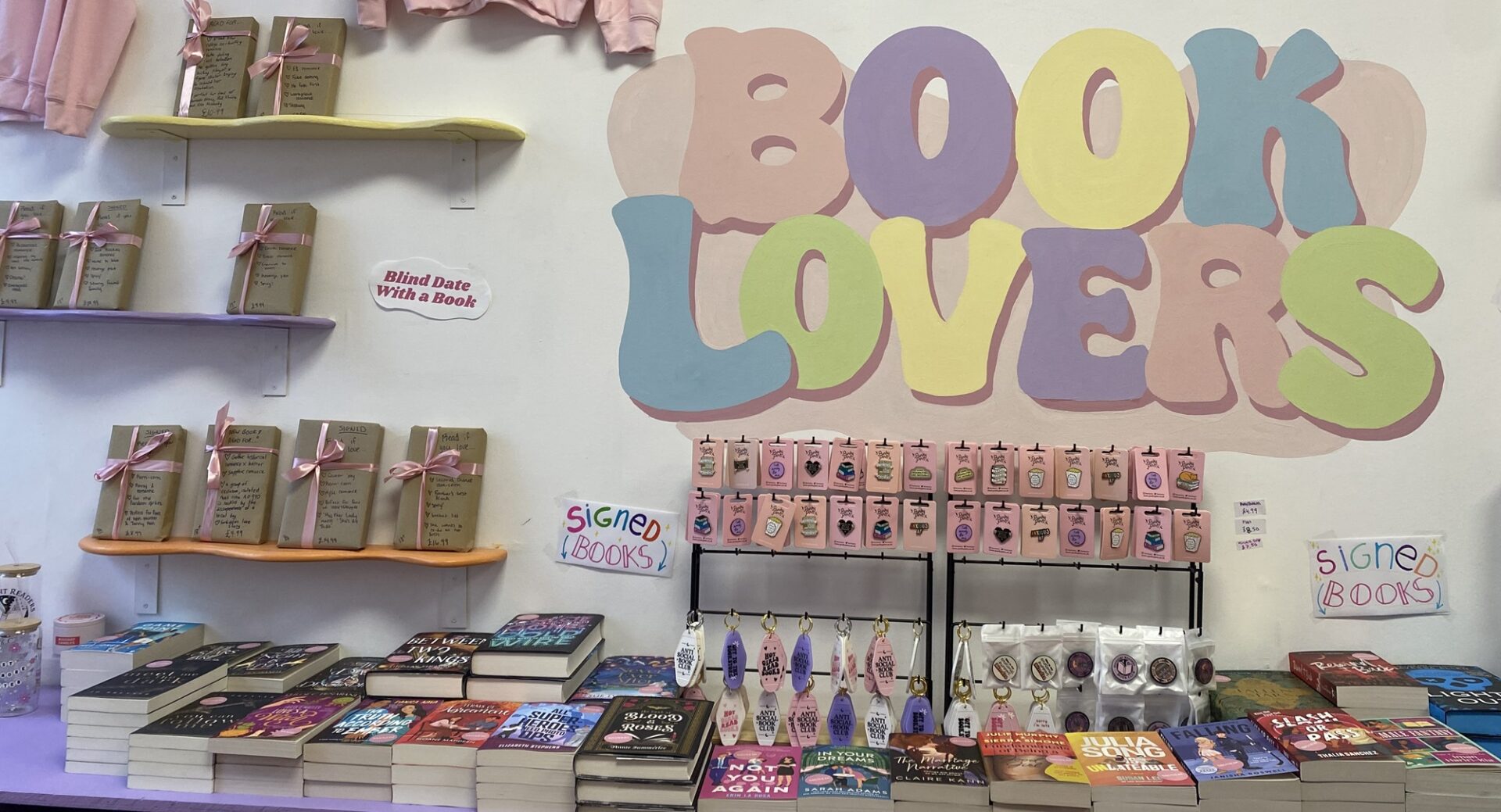 Sign on wall saying Book Lovers and surrounded by books on shelf
