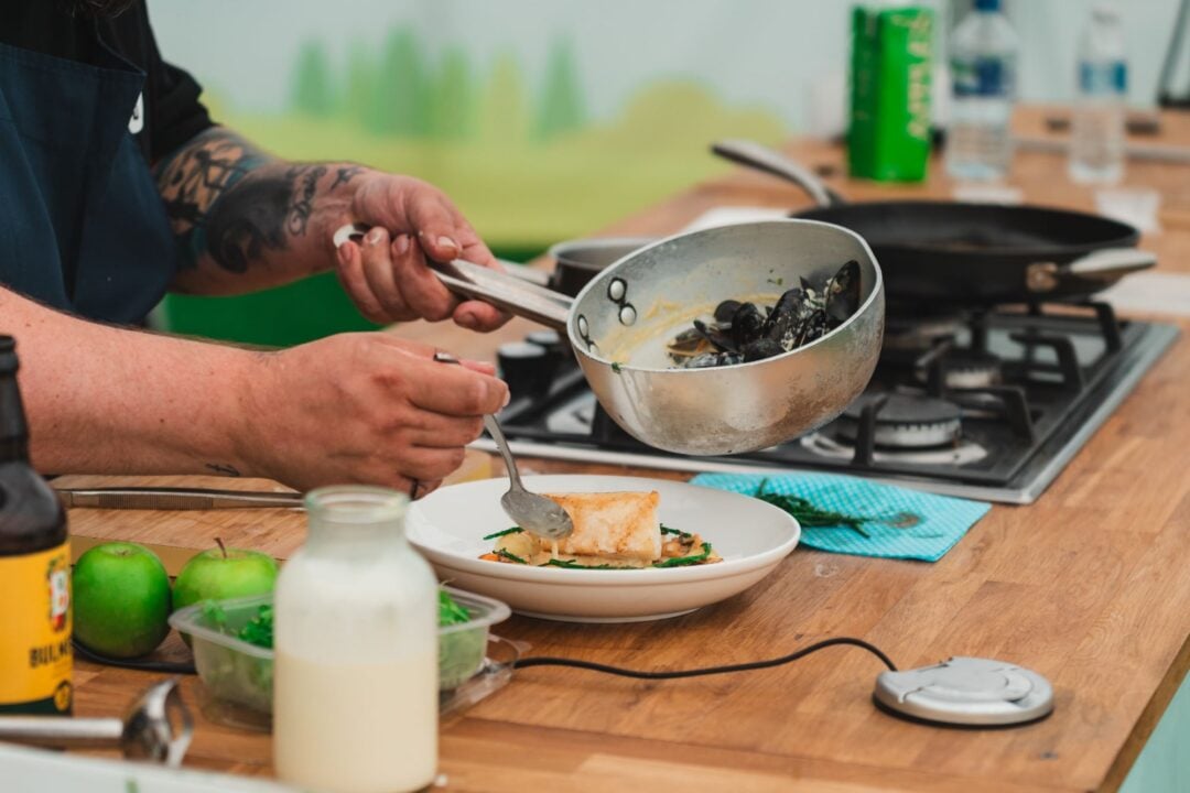 Close-up of someone serving food onto a plate.