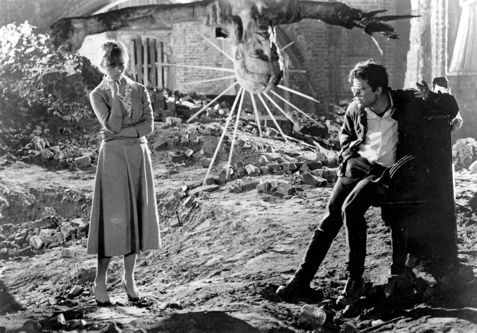 Black and white image of a man and woman outdoors.