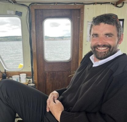 Scott Aston, skipper of Maid of The Forth, sitting in the boat cabin wearing a dark jumper and collared shirt.