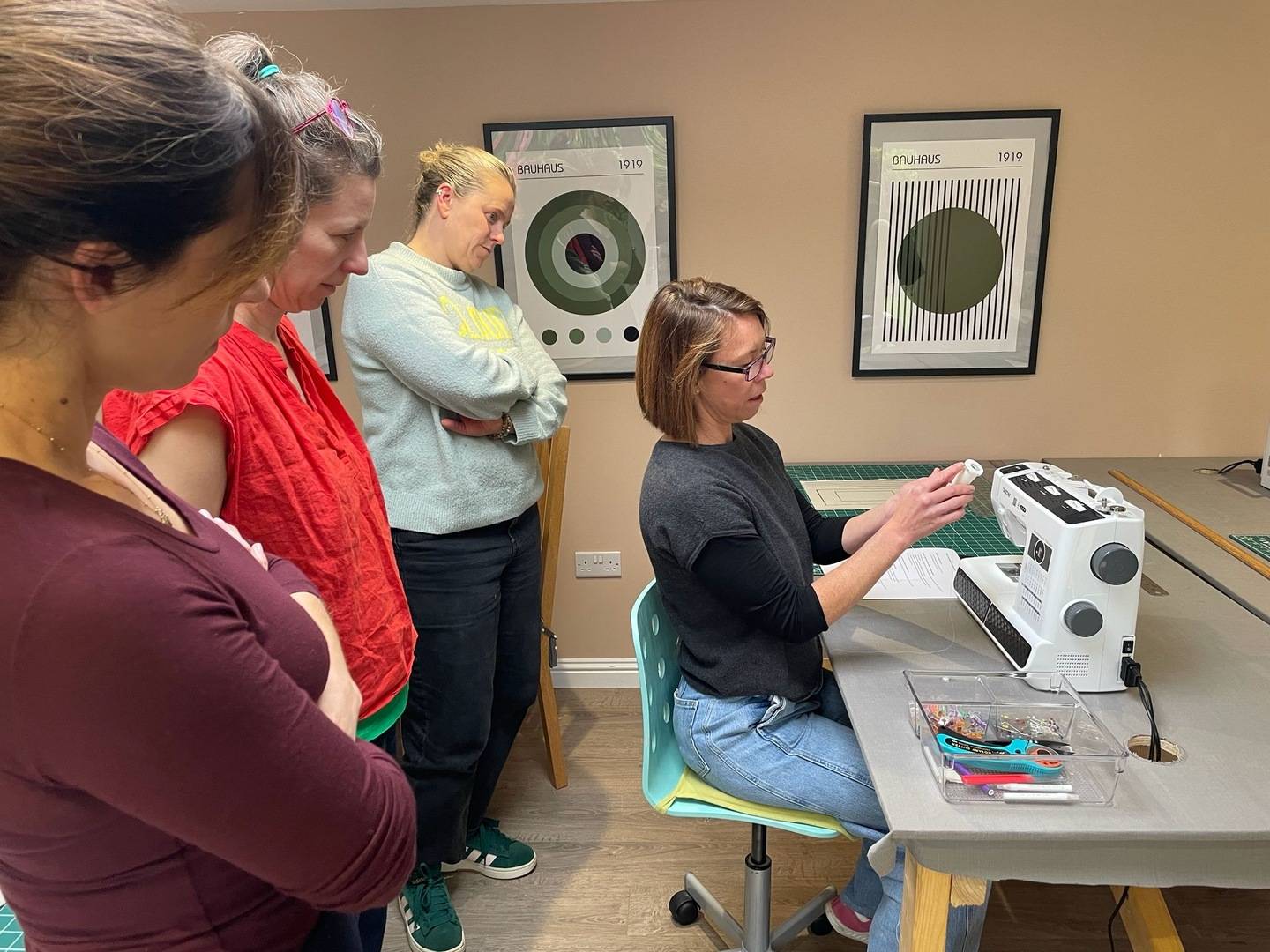 Lady demonstrating how to use a sewing machine at Joppa Sewing School
