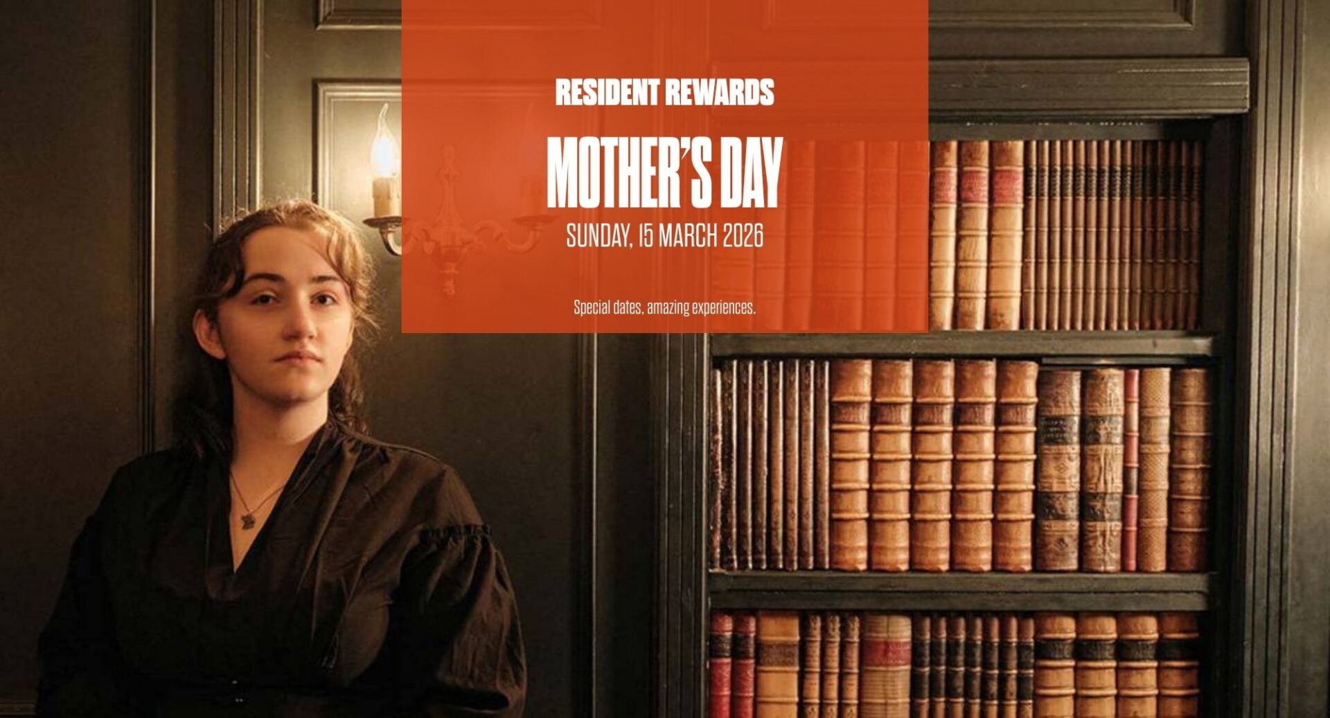 Lady standing next t a bookshelf with the words Residents Rewards Mothers Day