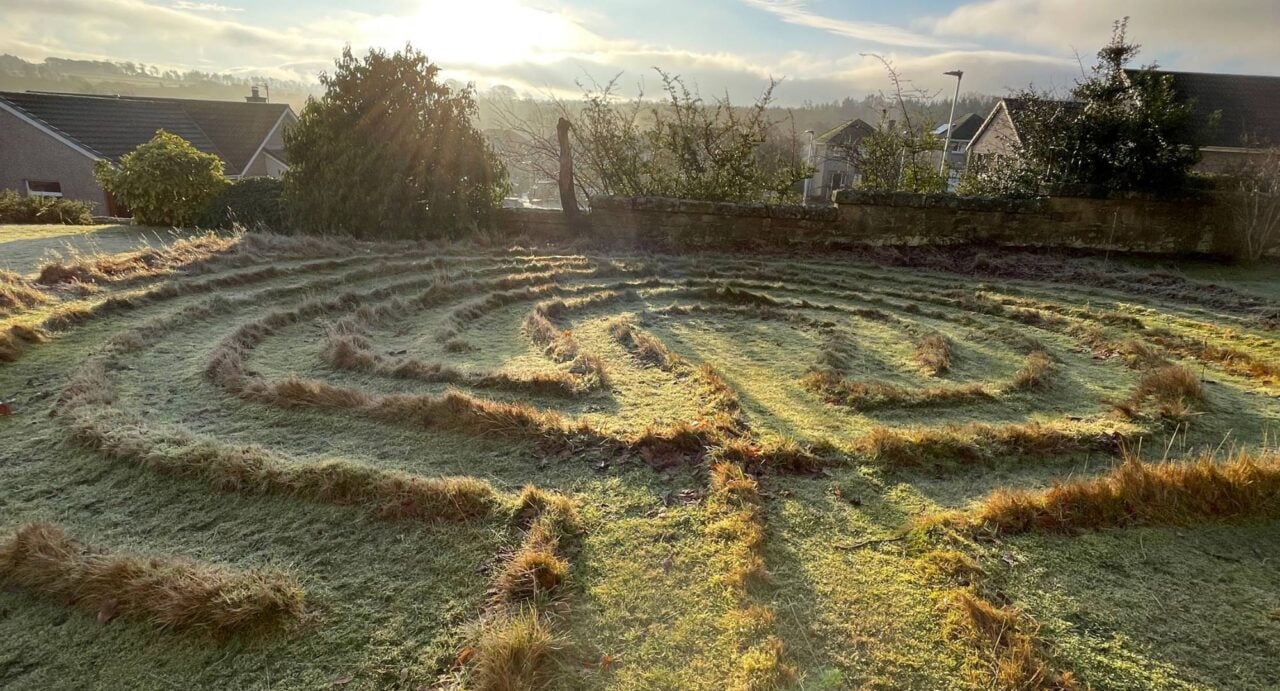 A grassy field in the form of a labyrinth.