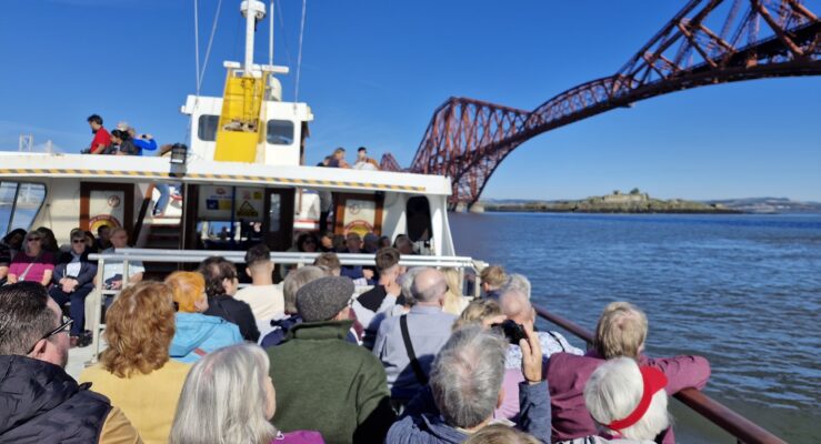 Forth Boat Tours boat going under the Forth Bridge