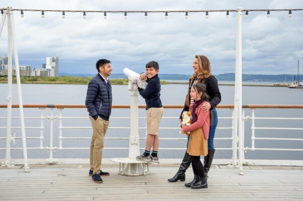 A family including a man, woman, little boy and girl on the deck of Britannia