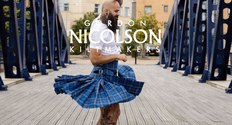 Man swirling kilt on Old Chain bridge in Leith