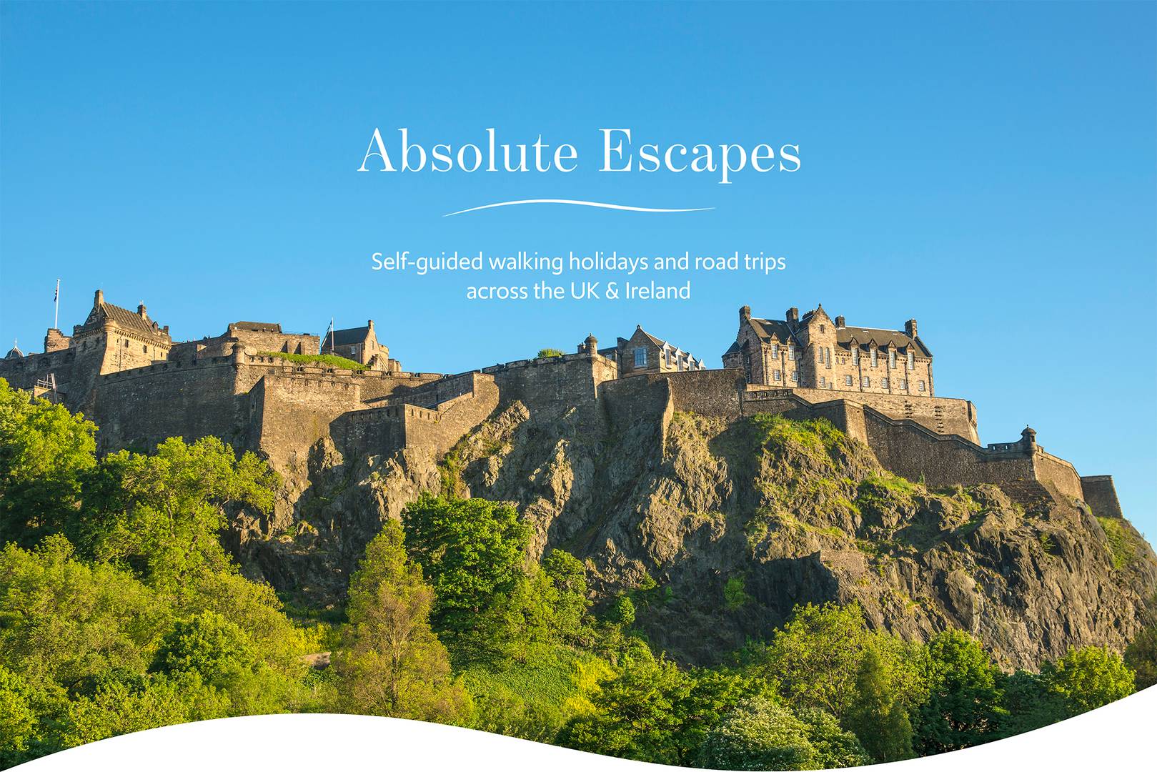 Edinburgh Castle from Princes Street, on a sunny day with blue skies. Text on the image reads: 'Absolute Escapes. Self-guided walking holidays and road trips across the UK & Ireland.',© Visit Scotland, Kenny Lam