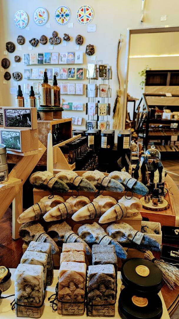 a sunny room with greeting cards, gifts, wall hangings, and soaps shaped like crow skulls