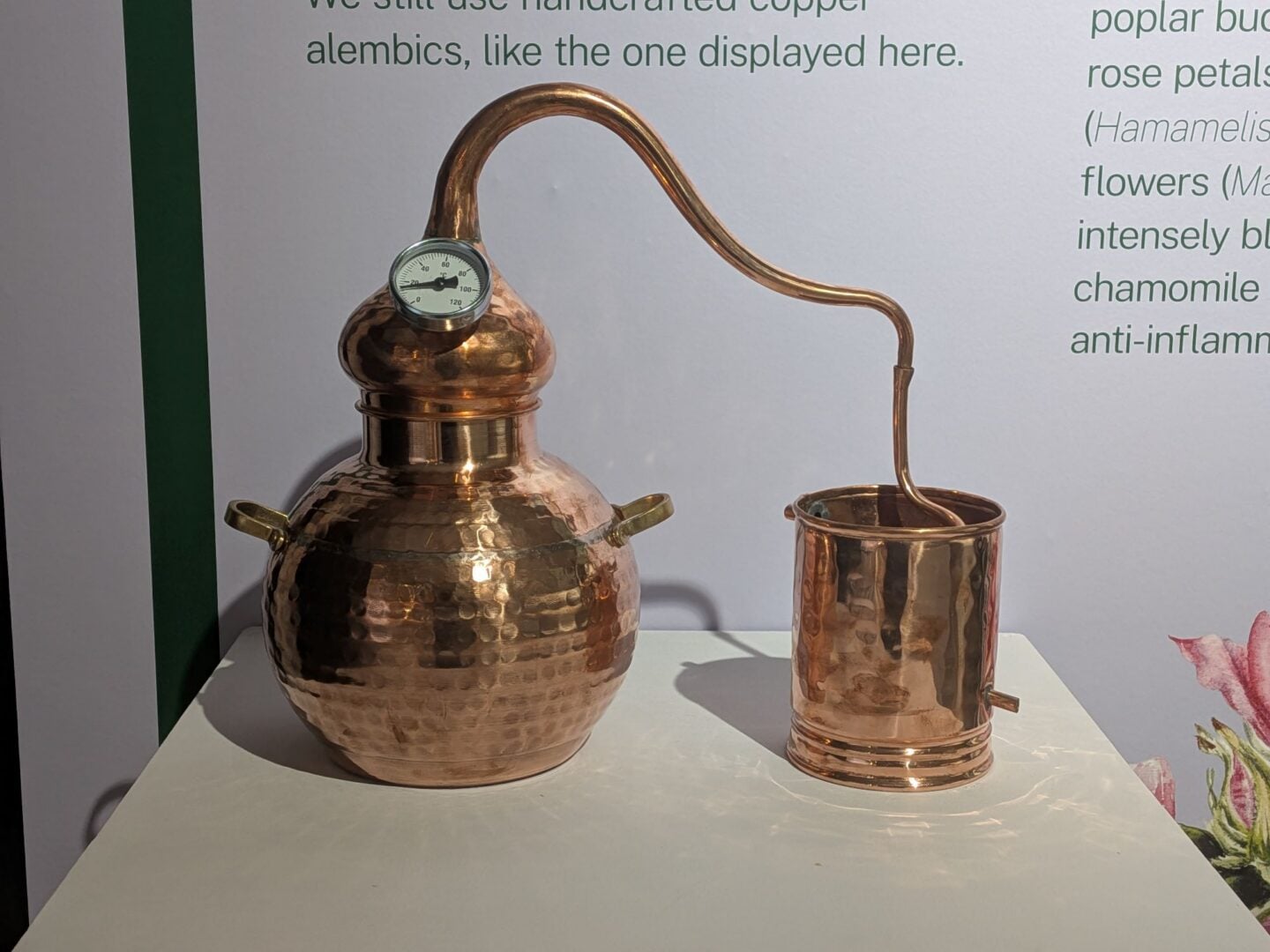 A copper pot sitting on a table.
