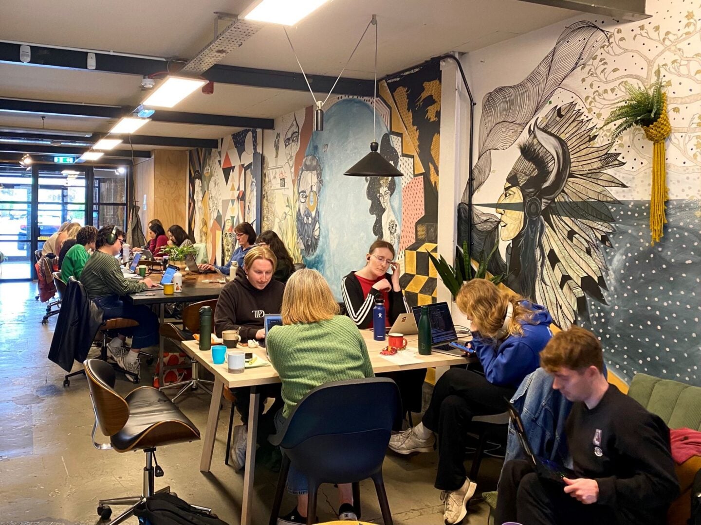 A room full of people sitting at desks.