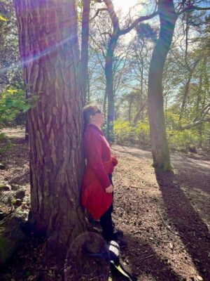 Lady leaning against a tree at Corstorphine hill