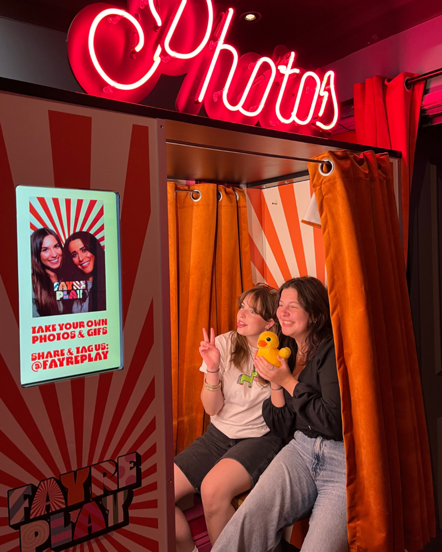 Two young women in a photo booth