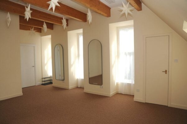 Mat Pilates studio with large bright windows and star ceiling decorations,© Owner Sano Studio Ltd