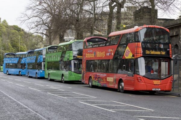 Edinburgh Bus Tours buses lined up at their Waterloo Place stop. the red CitySightseeing Edinburgh bus is front, followed by the green Edinburgh Tour bus, followed by two blue Regal Tour buses.,© Edinburgh Bus Tours