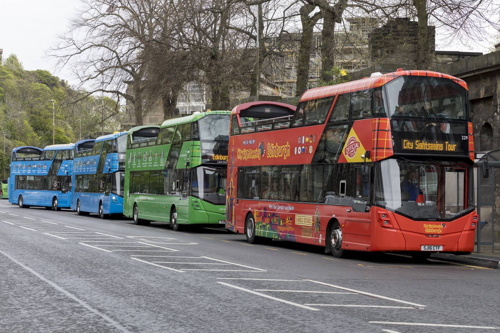 Edinburgh Bus Tours buses lined up at their Waterloo Place stop. the red CitySightseeing Edinburgh bus is front, followed by the green Edinburgh Tour bus, followed by two blue Regal Tour buses.,© Edinburgh Bus Tours