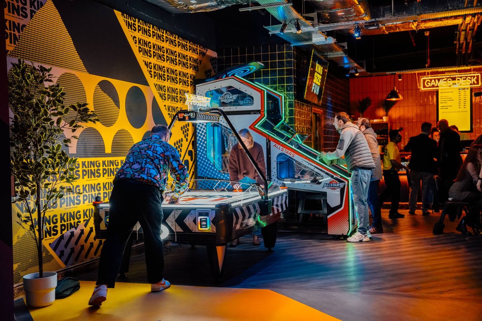 People playing Air Hockey at King Pins