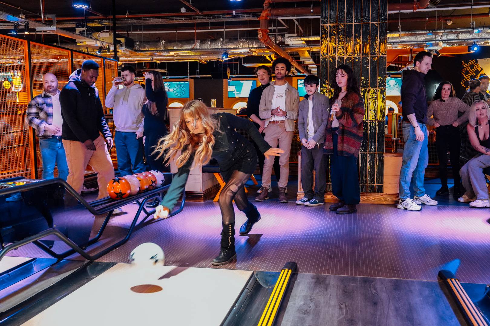 Lady Bowling with crowd looking on at King Pins