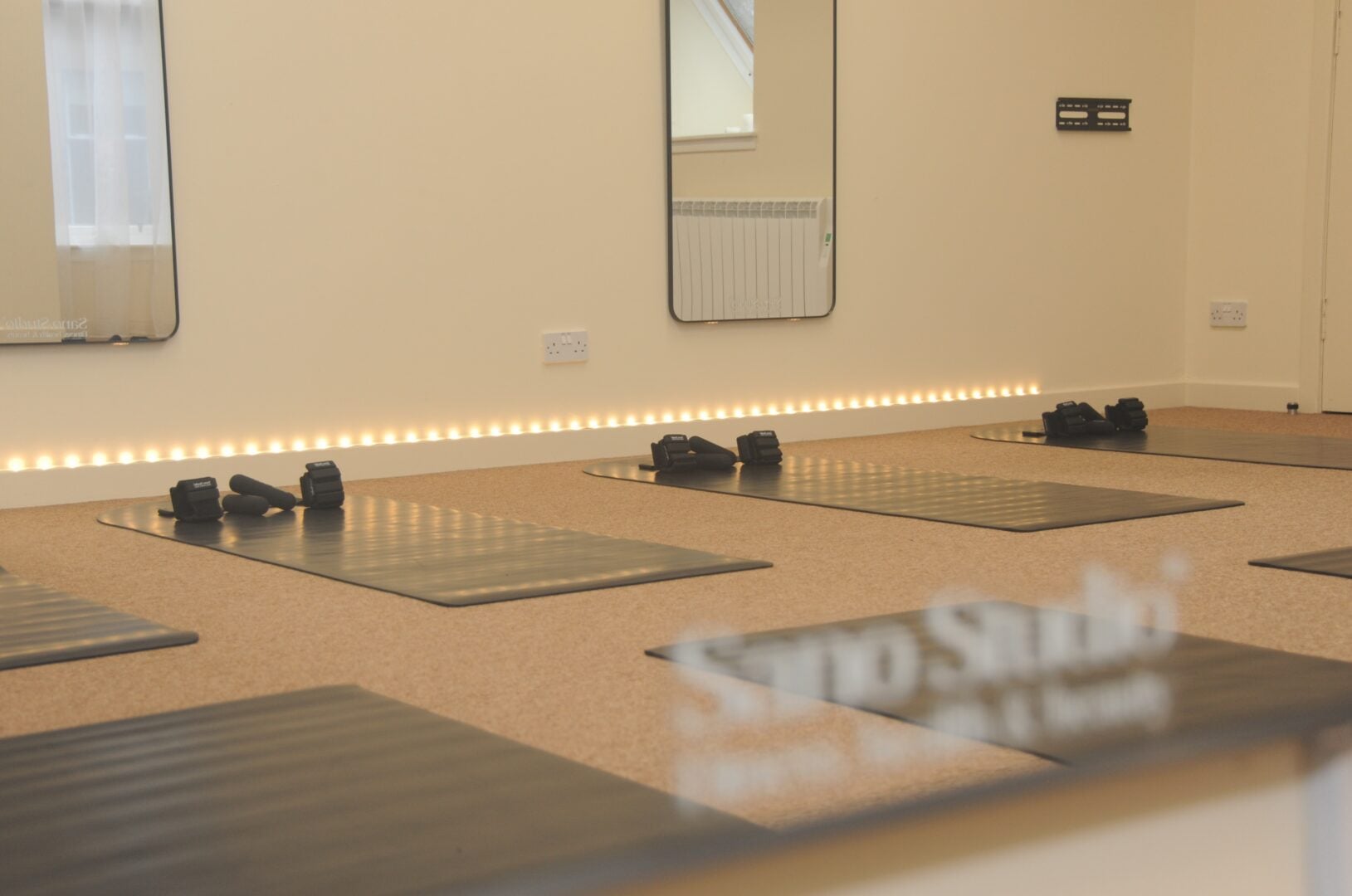Gym mats ready for a pilates class at Sano Studio