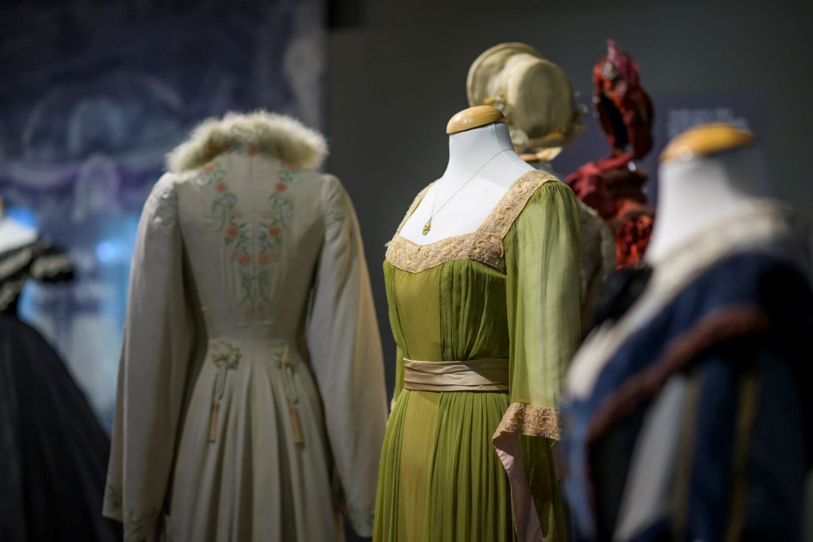 3 dresses displayed on mannequins.