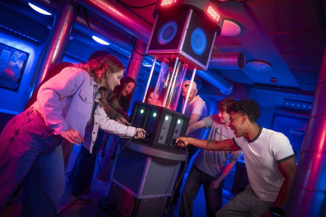 group trying to solve Team Machine escape room problem