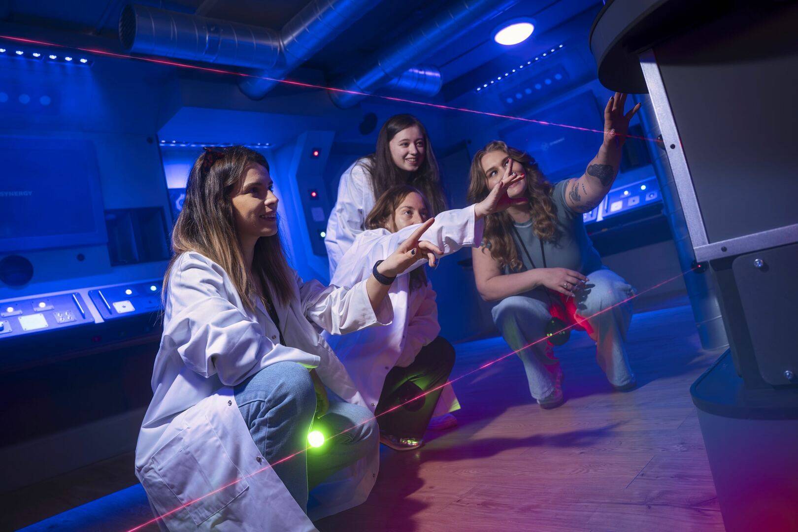 group trying to solve Team Machine escape room problem