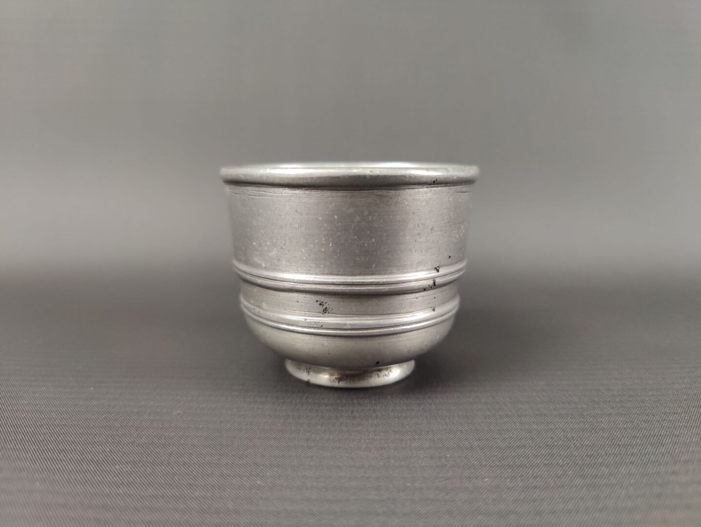 A small, tin coloured bowl.