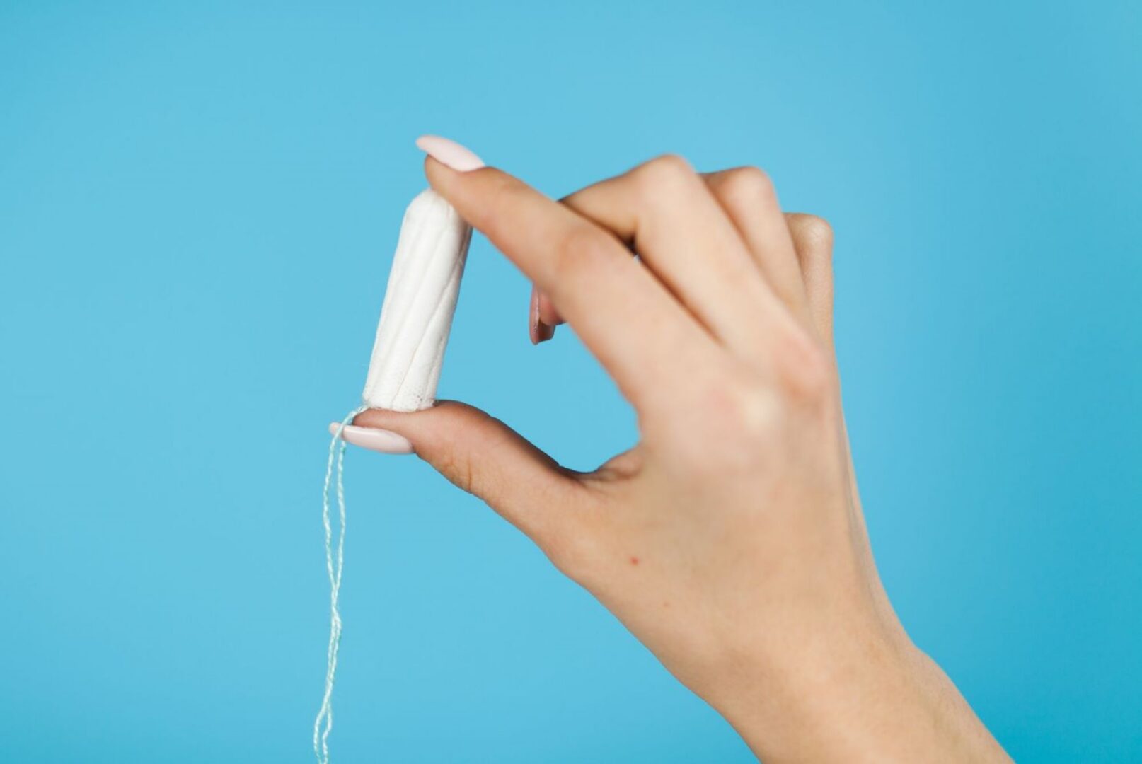 Close-up of a hand holding a tampon.