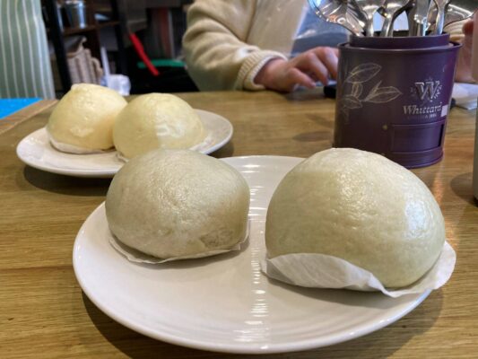 2 plates of uncooked bao buns.