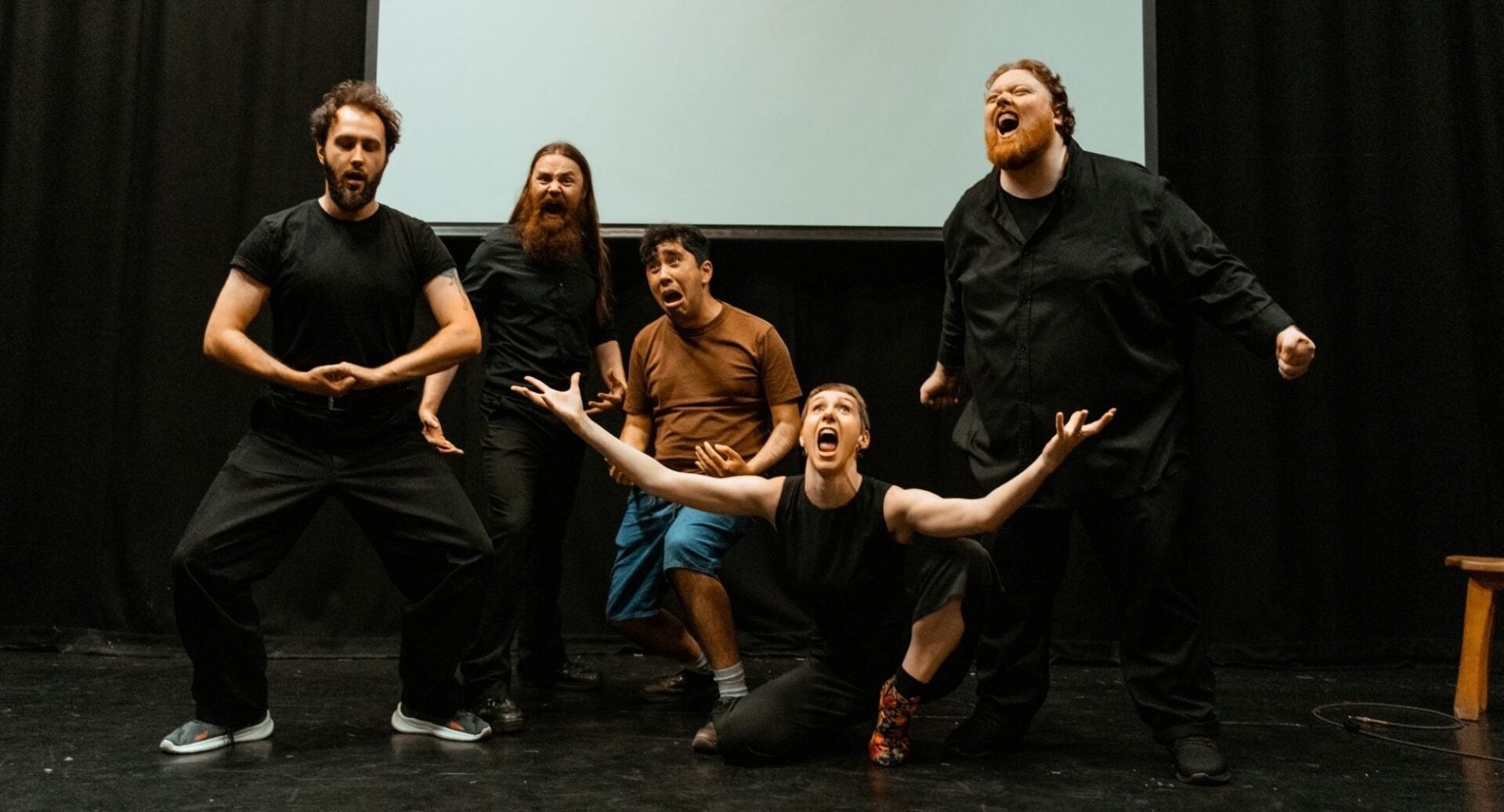 5 people performing on a stage.