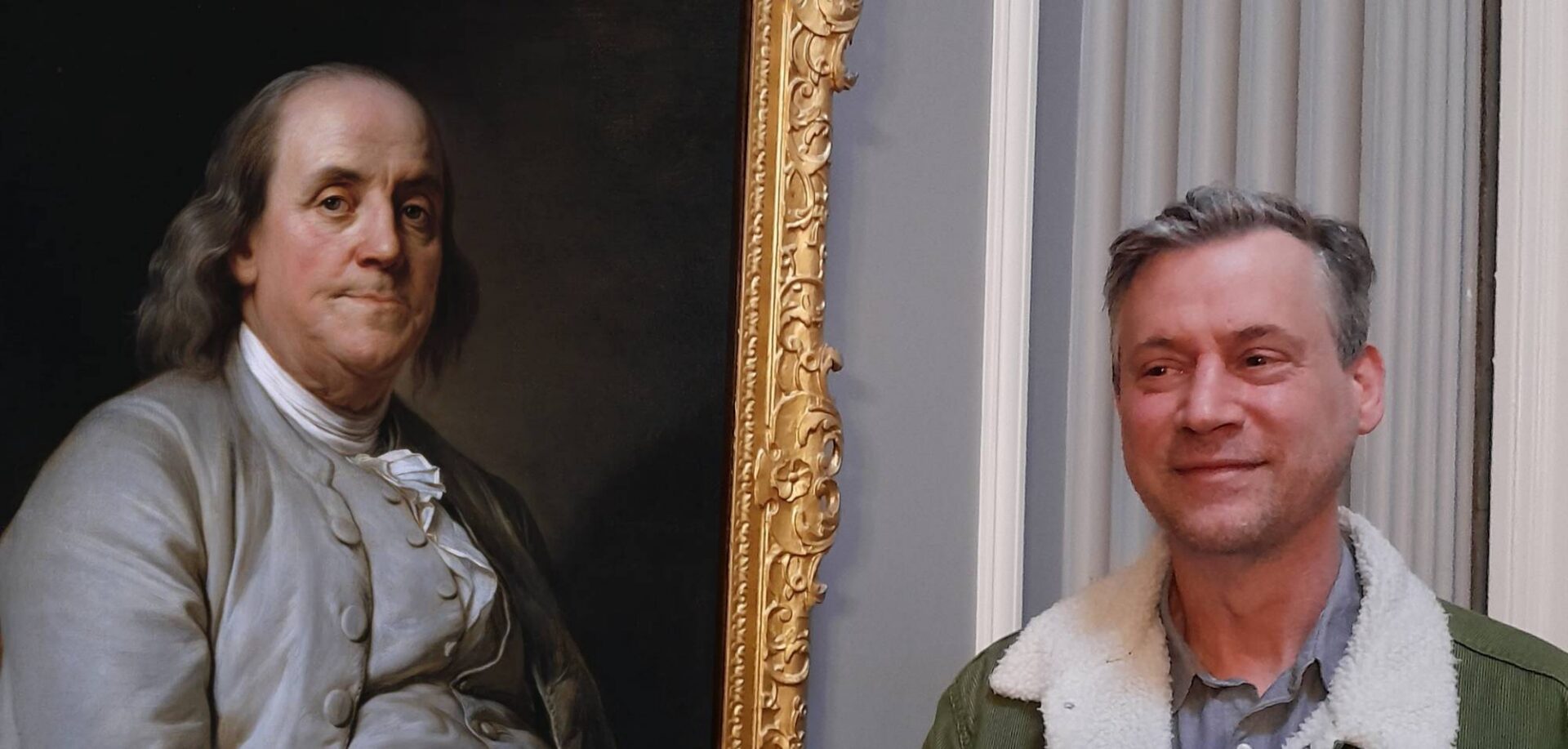 Rick Conte next to a portrait of Benjamin Franklin